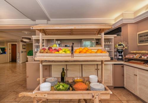 a kitchen with a table with fruits and vegetables at Hotel Siesta in Lido di Camaiore