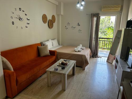 a living room with a couch and a table at Central House Karistos in Karistos