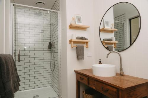 a bathroom with a sink and a mirror at Treehouse Hideaway at Rekindle Treehouses in Opua
