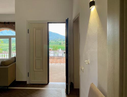 a door to a room with a view of a balcony at Villa Tragos in Vlorë