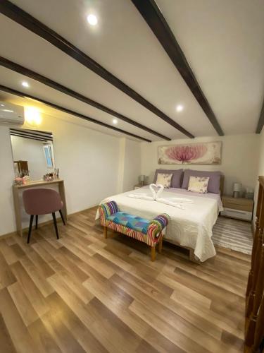a bedroom with a bed and a table and a chair at Apartman u srcu antičke Pule in Pula