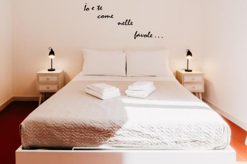 a bedroom with a large bed with two night stands at Le Contrade Vico Alba in Monopoli
