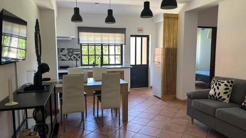 a living room with a table and chairs and a couch at Eco Natura Falcoeira - Praia da Luz in Montinhos da Luz