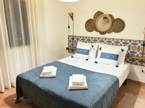 a bedroom with a bed with two towels on it at Eco Natura Falcoeira - Praia da Luz in Montinhos da Luz