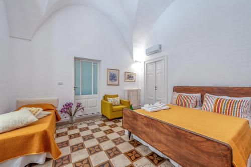 a bedroom with two beds and a couch at San Biagio Apartment Lecce in Lecce