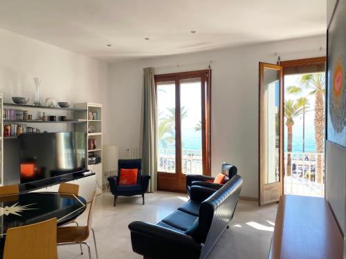 a living room with a view of the ocean at Exclusive Beachfront Haven in Costa Brava in Lloret de Mar