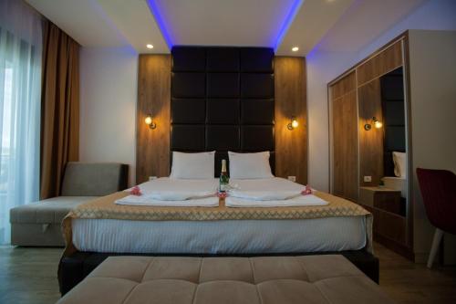 a bedroom with a large bed with a large headboard at Apartments DABI in Ulcinj