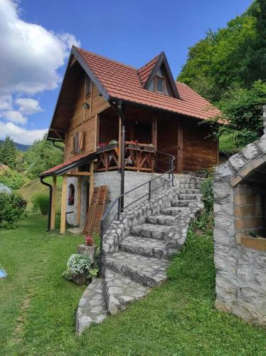 a house with a stone staircase in front of it at Vila VRABAC in Priboj