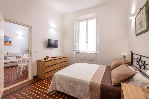 a bedroom with a bed and a living room at Appartamento Letterario - Art & Design in Grosseto