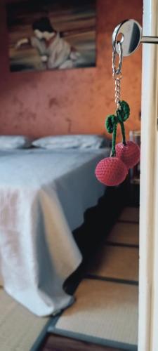 a pair of earrings hanging from a door with a bed at Monferrato Inn in Rivarone