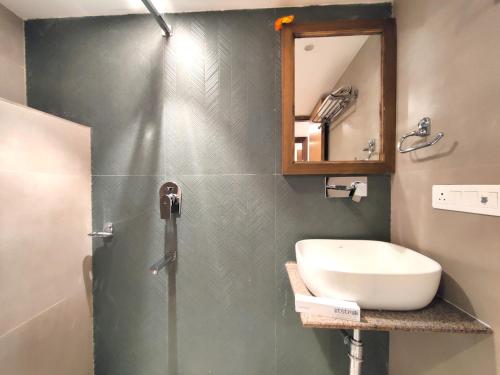 a bathroom with a sink and a mirror at Sangam by Stotrak, Jhula Ghar Mussoorie in Mussoorie