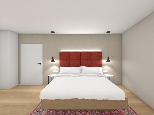 a bedroom with a large bed with a red headboard at Schmidtburger Hof in Weiler