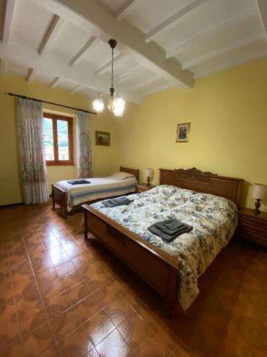 a bedroom with two beds and a large window at Da Nonna Gio' in Pratovecchio