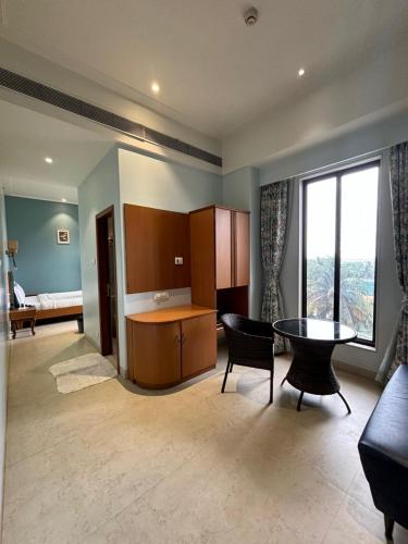 a living room with a table and a dining room at The Hub Link in Mumbai