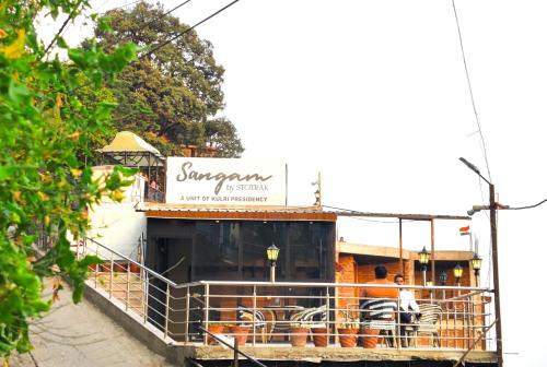 a restaurant with a sign on the front of it at Sangam by Stotrak, Jhula Ghar Mussoorie in Mussoorie