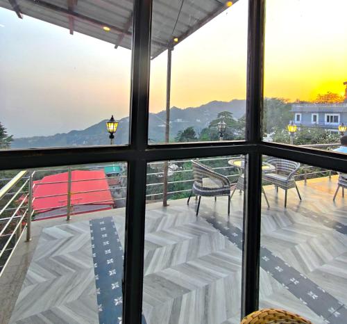 a view from the window of a balcony with a view at Sangam by Stotrak, Jhula Ghar Mussoorie in Mussoorie