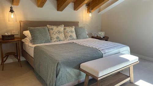 a bedroom with a large bed and two tables at Hotel Villa Aurora in Lezzeno