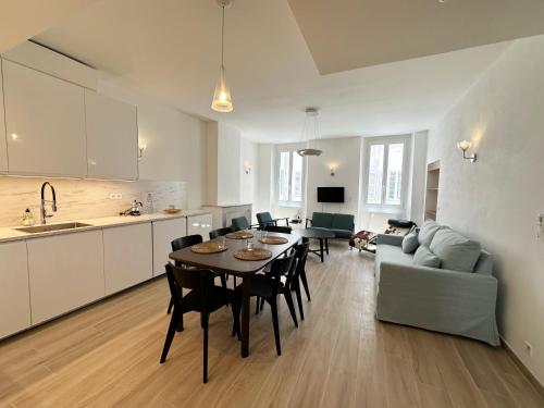 une cuisine et un salon avec une table et des chaises dans l'établissement Apartments, Cannes, à Cannes