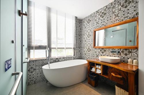 a bathroom with a large tub and a sink at Sky Gem Central Hotel in Ho Chi Minh City