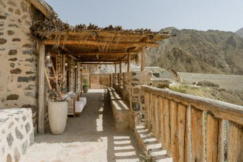 a balcony of a house with a view of the mountains at Najd Al Meqsar, By Sharjah Collection - Adults Only in Khor Fakkan
