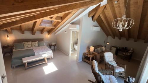 an overhead view of a bedroom with a bed and chairs at Hotel Villa Aurora in Lezzeno