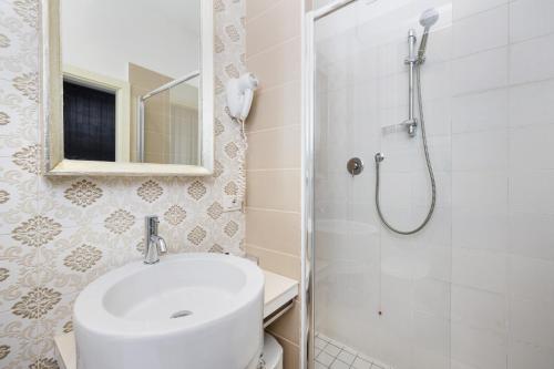 a bathroom with a toilet and a sink and a shower at Hotel Maggiore in Bologna