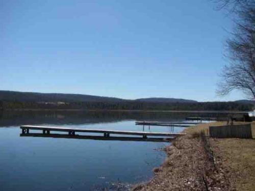 a lake with a dock in the middle of it at Serenity on Lamoka in Hammondsport
