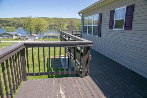 a wooden deck on the side of a house at Tiki on the Lake in Hammondsport