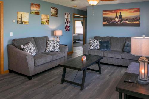 a living room with two couches and a coffee table at Tiki on the Lake in Hammondsport