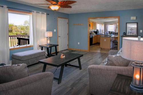 a living room with a table and chairs and a kitchen at Tiki on the Lake in Hammondsport