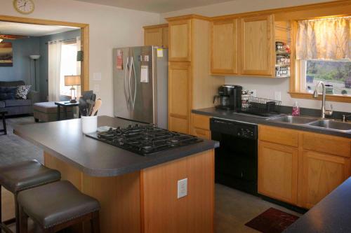 a kitchen with a stove and a refrigerator at Tiki on the Lake in Hammondsport