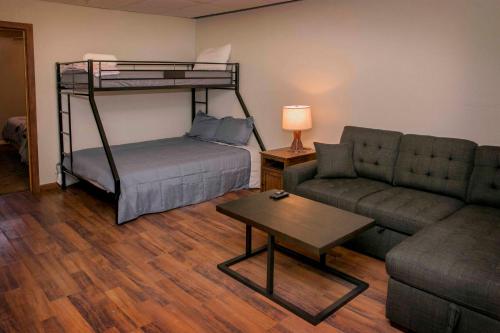 a living room with a bunk bed and a couch at Tiki on the Lake in Hammondsport