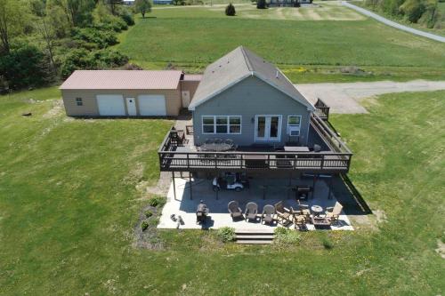 an aerial view of a house with a deck at Tiki on the Lake in Hammondsport