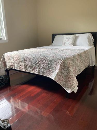 a bed with a white bedspread and pillows on it at Keuka Glory in Hammondsport