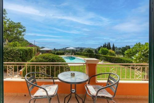 a patio with a table and chairs and a pool at Even Ezer with private pool in Pouládes