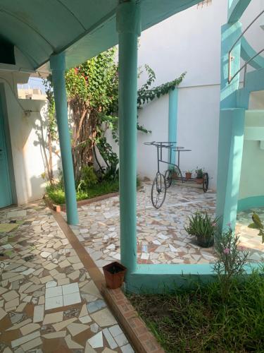 a bike parked under a porch with a building at Studio Salam in Ziguinchor