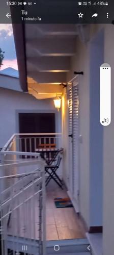 a room with a balcony with a table and a balcony at B&B A casa di Antonella in Scauri