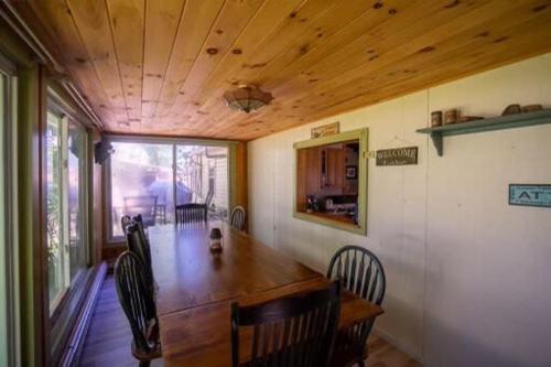 a dining room with a wooden table and chairs at Memory Island in Hammondsport