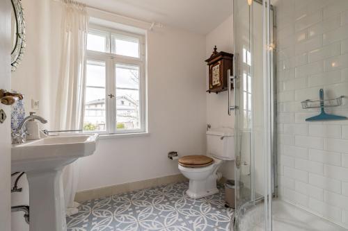 La salle de bains est pourvue de toilettes, d'un lavabo et d'une fenêtre. dans l'établissement Ferienwohnung Königssee, à Sassnitz