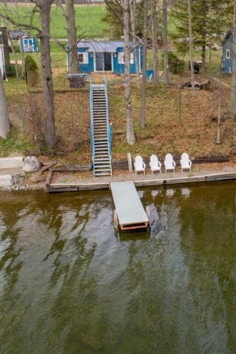 a dock with chairs and a ramp in the water at Camp Waneta in Hammondsport