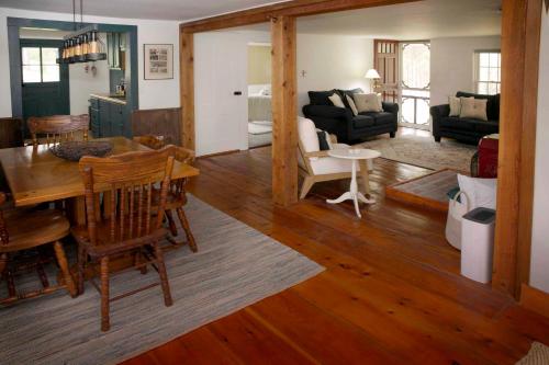 a living room with a table and a dining room at Green Acres Finger Lakes in Hammondsport
