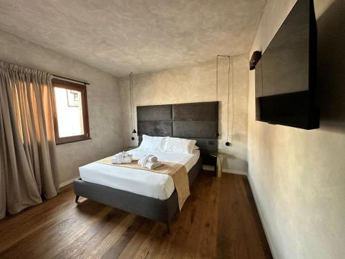 a bedroom with a large bed and a television at Residenza Leutari in Rome