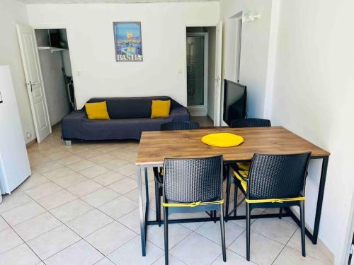 - un salon avec une table et des chaises dans l'établissement Location entre mer, montagne et rivières, à Casanova