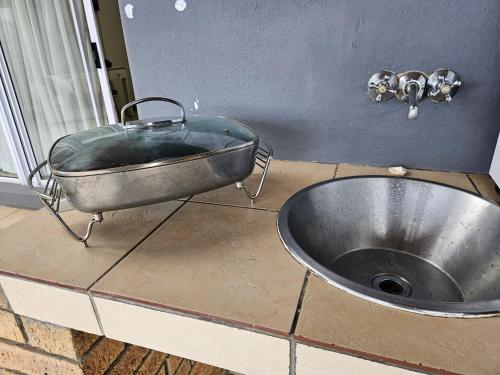 a metal sink sitting on top of a counter at Swaeltjie in Somerset West