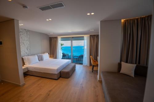 a hotel room with a bed and a balcony at Hotel Teuta in Sarandë