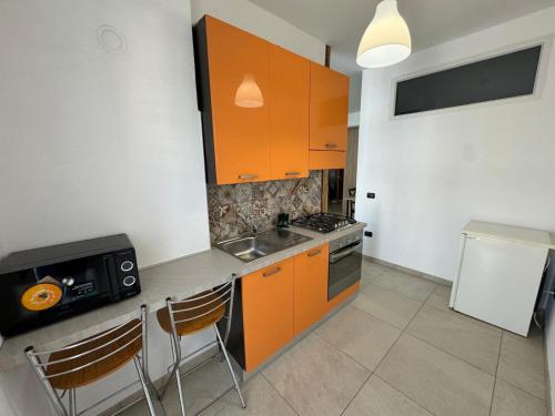 a kitchen with orange cabinets and a sink and a stove at Wild Luxury Home in Rome