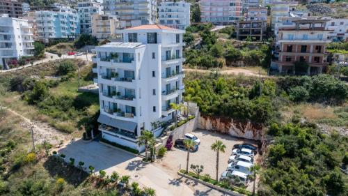 an aerial view of a white building in a city at Hotel Teuta in Sarandë
