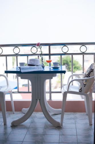 a blue table and two chairs on a balcony at Thipurai City Hotel in Hua Hin