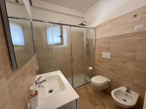 a bathroom with a shower and a sink and a toilet at La Casa al mare Torre San Giovanni in Torre San Giovanni Ugento