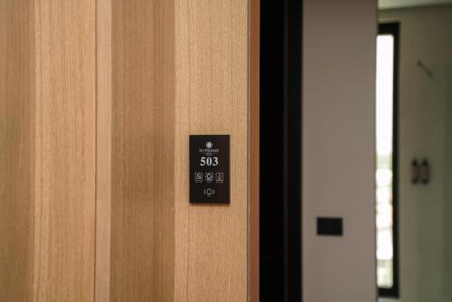 a close up of a door with a clock on it at Supreme Hotel in Golem